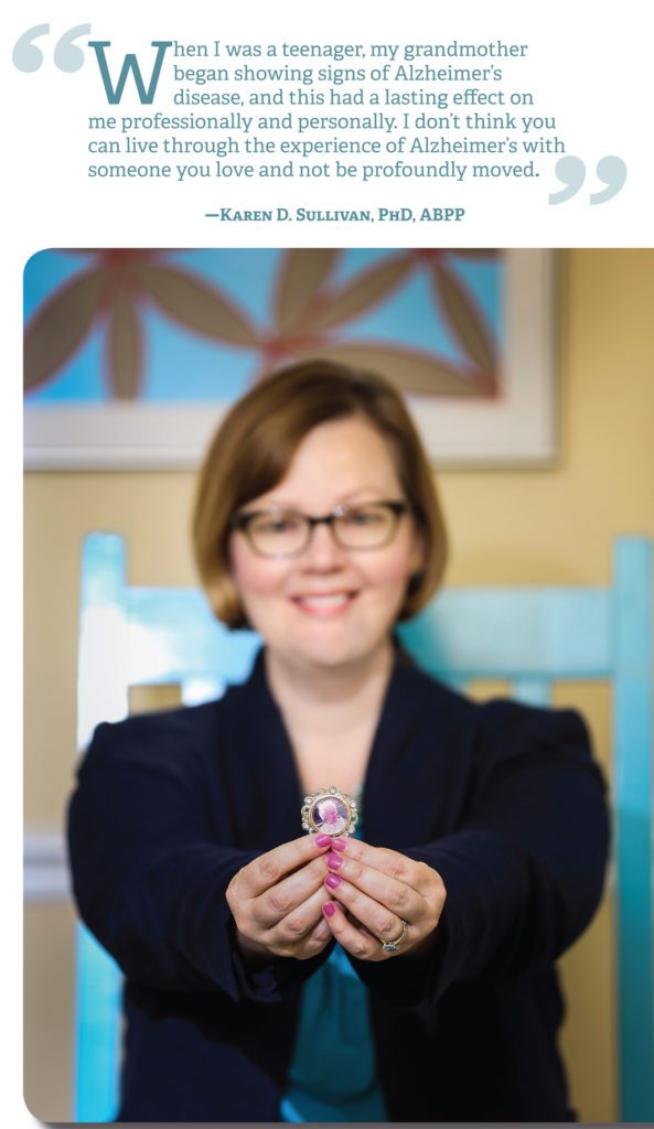 A woman holding a pink phone in her hands.